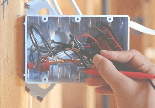 Licensed electrician working on electrical panel wiring